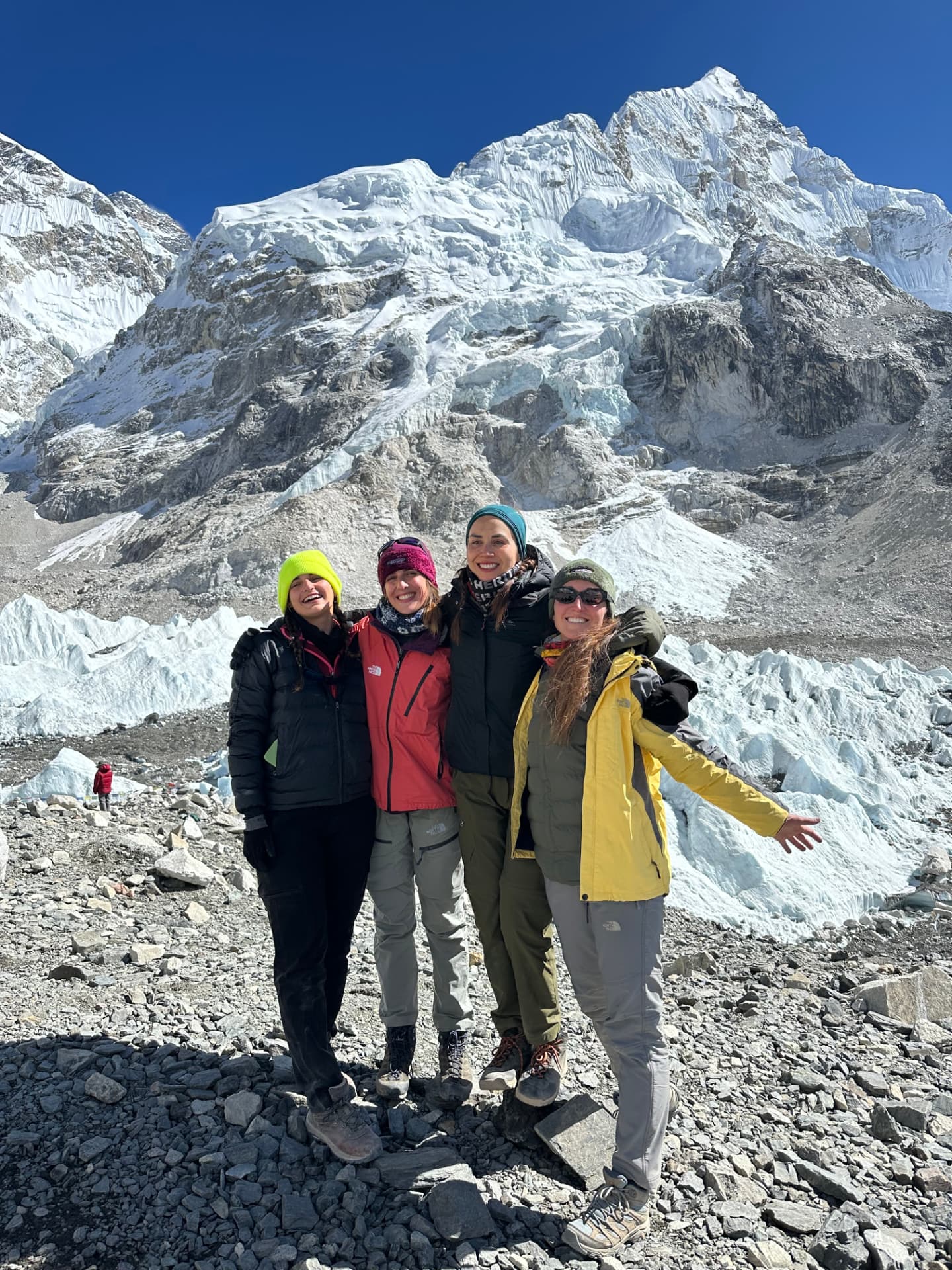 Four women celebrating together at Everest Base Camp